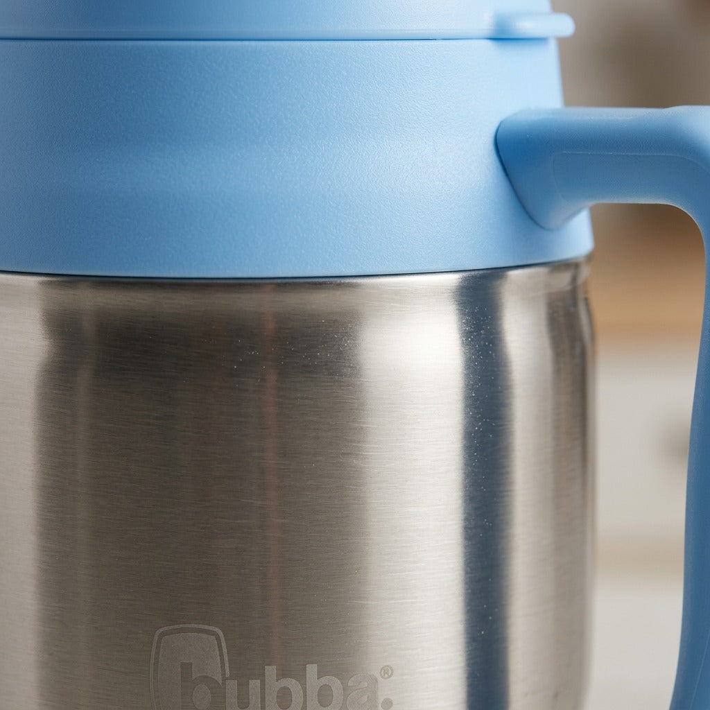 Macro detail of a 34 oz bubba Classic Mug showing the brushed stainless steel body and blue lid.