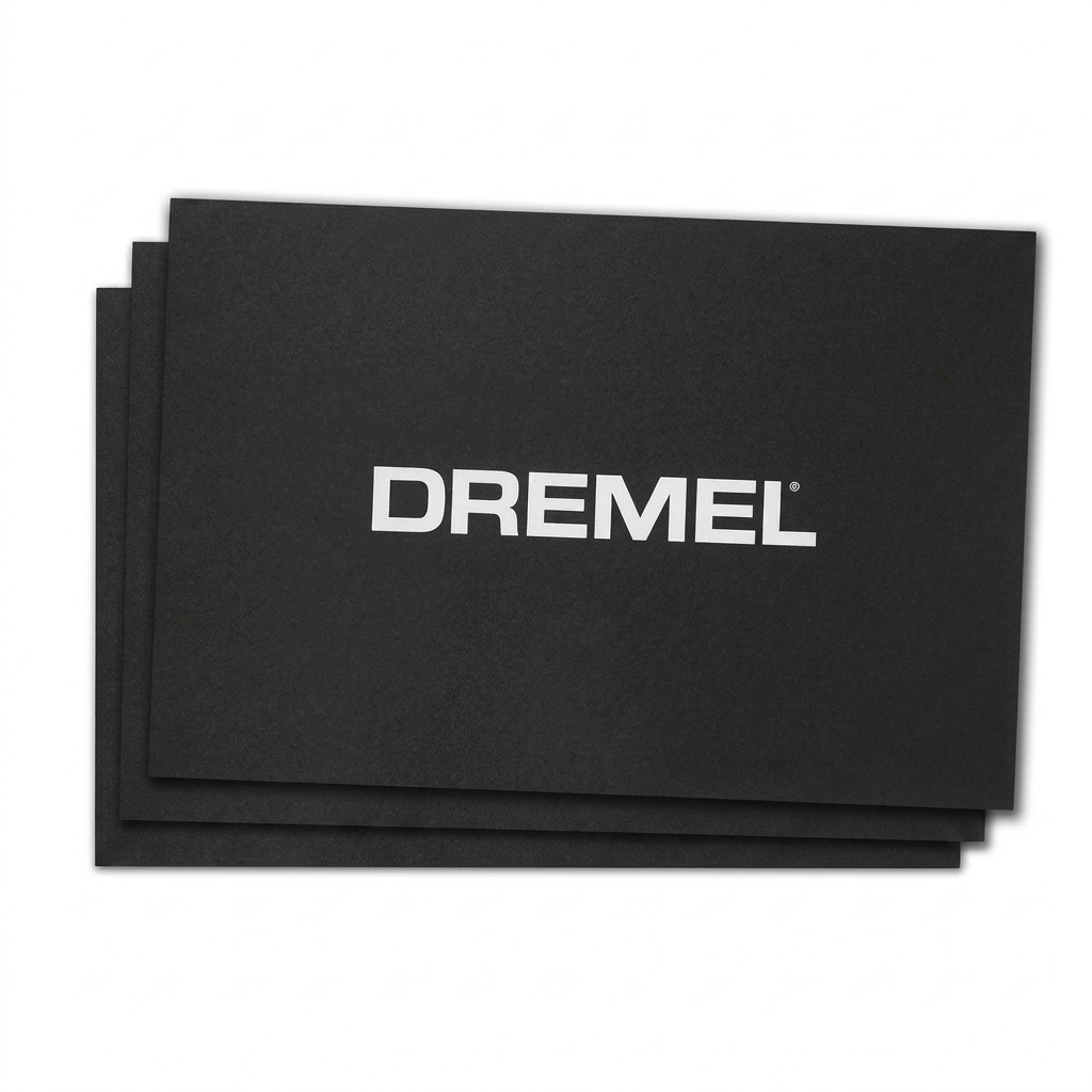 A crisp hero shot of the Dremel 3D40 Build Sheet 3-pack, featuring three black textured sheets stacked to show the edges, with the centered "DREMEL" logo visible.